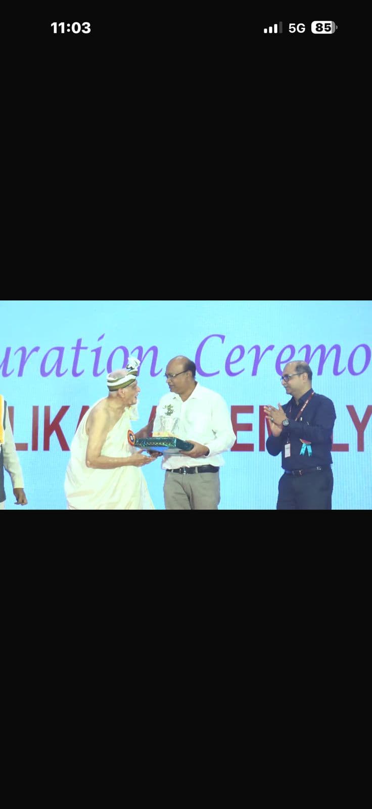 Receiving appreciation award on stage during a recognition ceremony